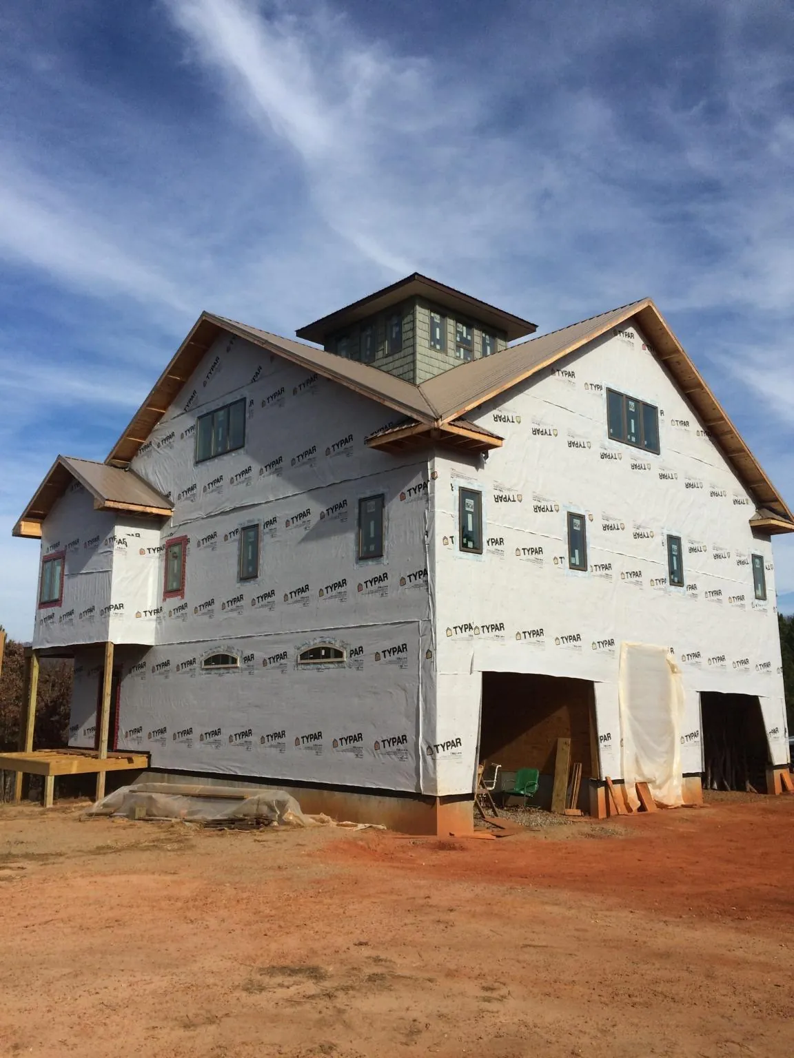 New two story house under construction with a cupola and gabled roofs in Amherst